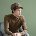 portrait-young-man-with-hat-sitting-chair
